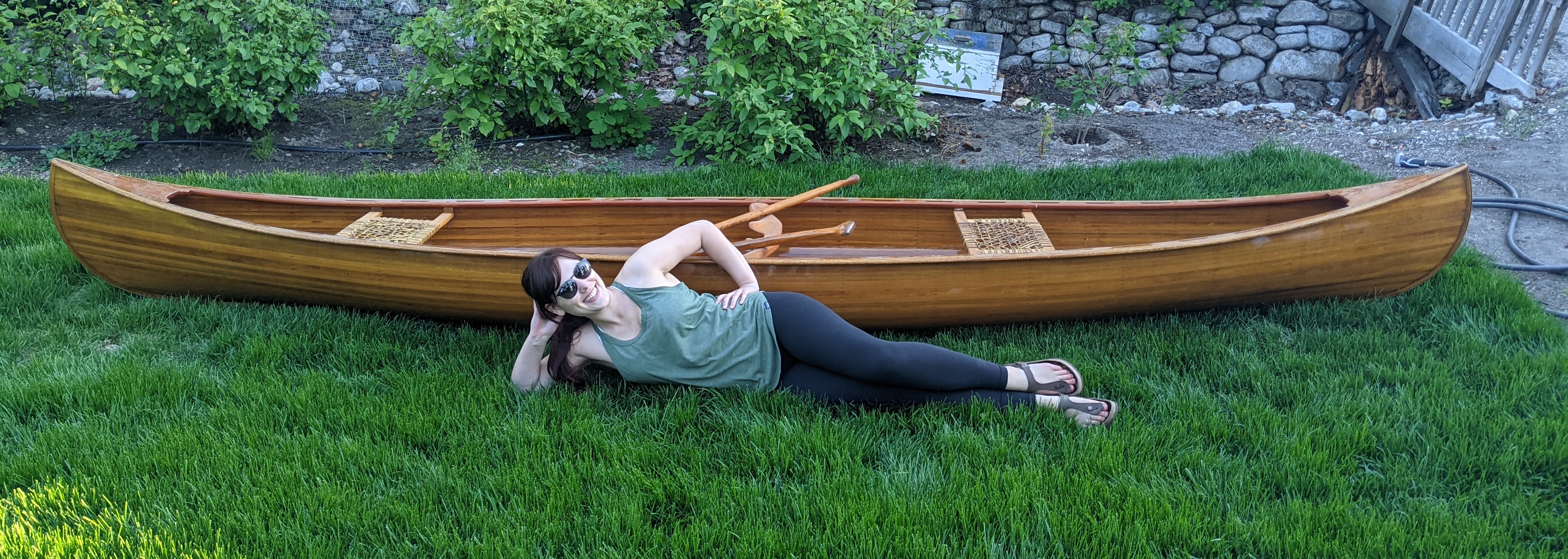 This photo is a banner photo depicting E.A. Gira in front of their cedar canoe.